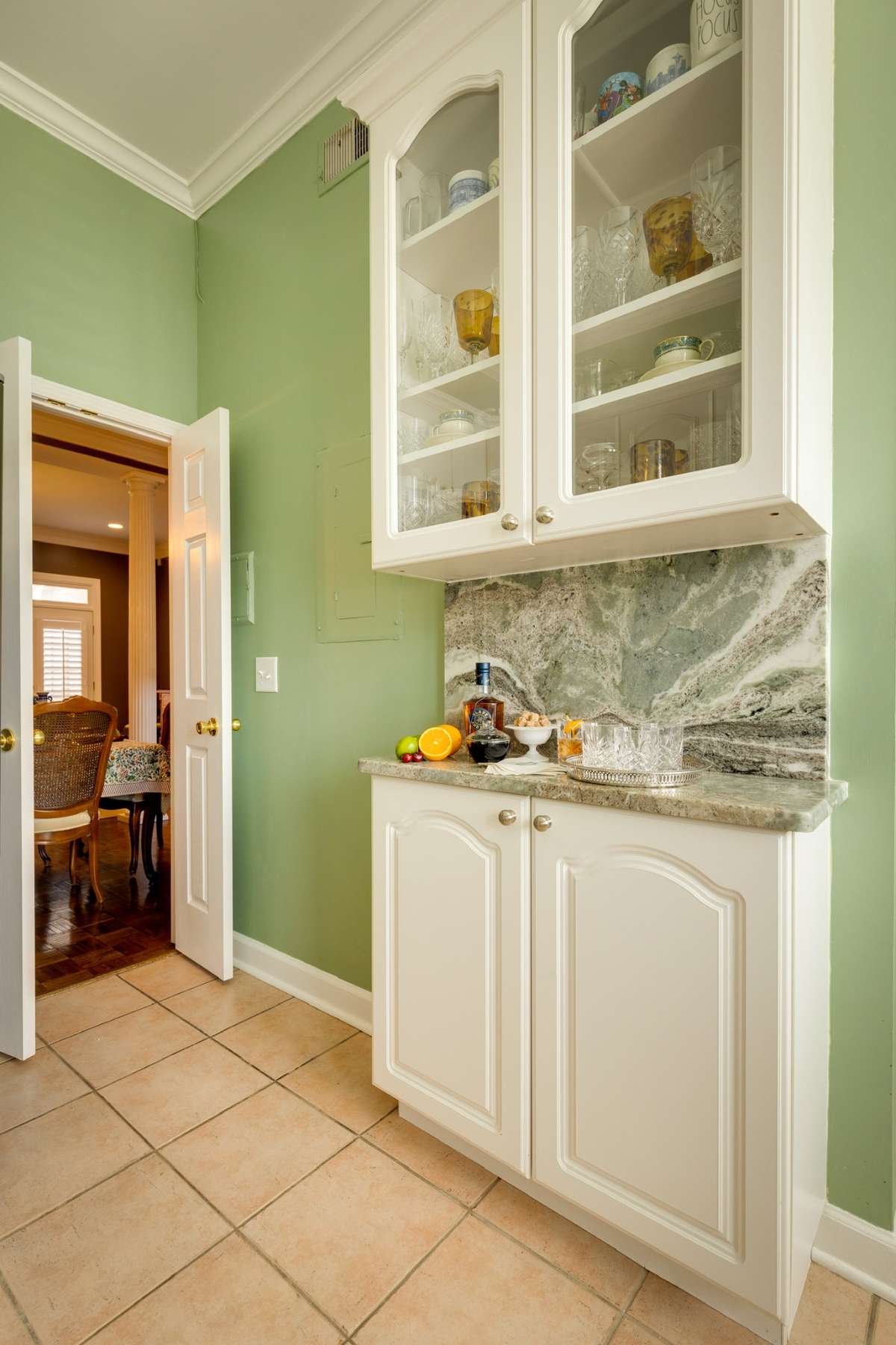 Coffee Bar with glass-faced cabinetry to display your seasonal China and double doors which seamlessly flow to the Formal Dining Room.