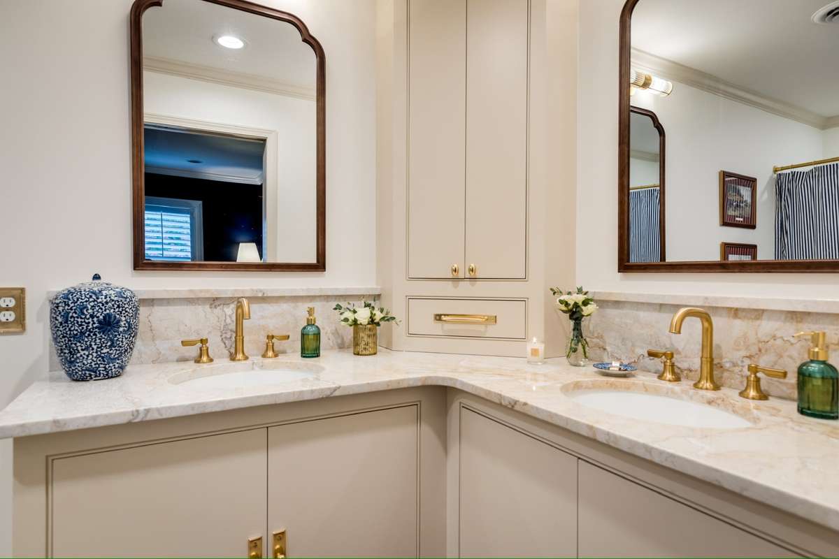 Timeless style with marble countertops, gold fixtures + hardware.