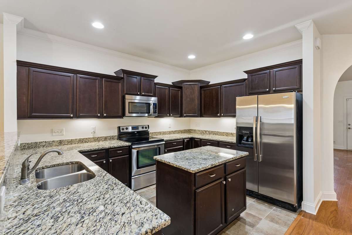 Dreamy kitchen features an abundance of quality cabinetry and granite countertops! 217 Whiteamore Run, Murfreesboro, TN 37128
