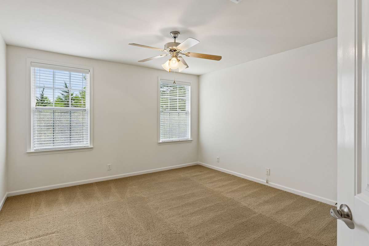 Bedroom three includes a ceiling fan, double windows, and ample closet space! 217 Whiteamore Run, Murfreesboro, TN 37128