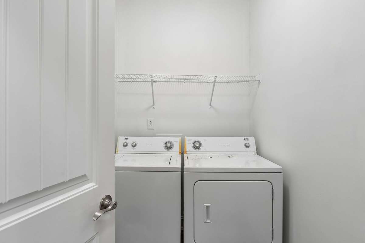 Laundry room includes a tile floor, shelving, and the washer & dryer are included! 217 Whiteamore Run, Murfreesboro, TN 37128