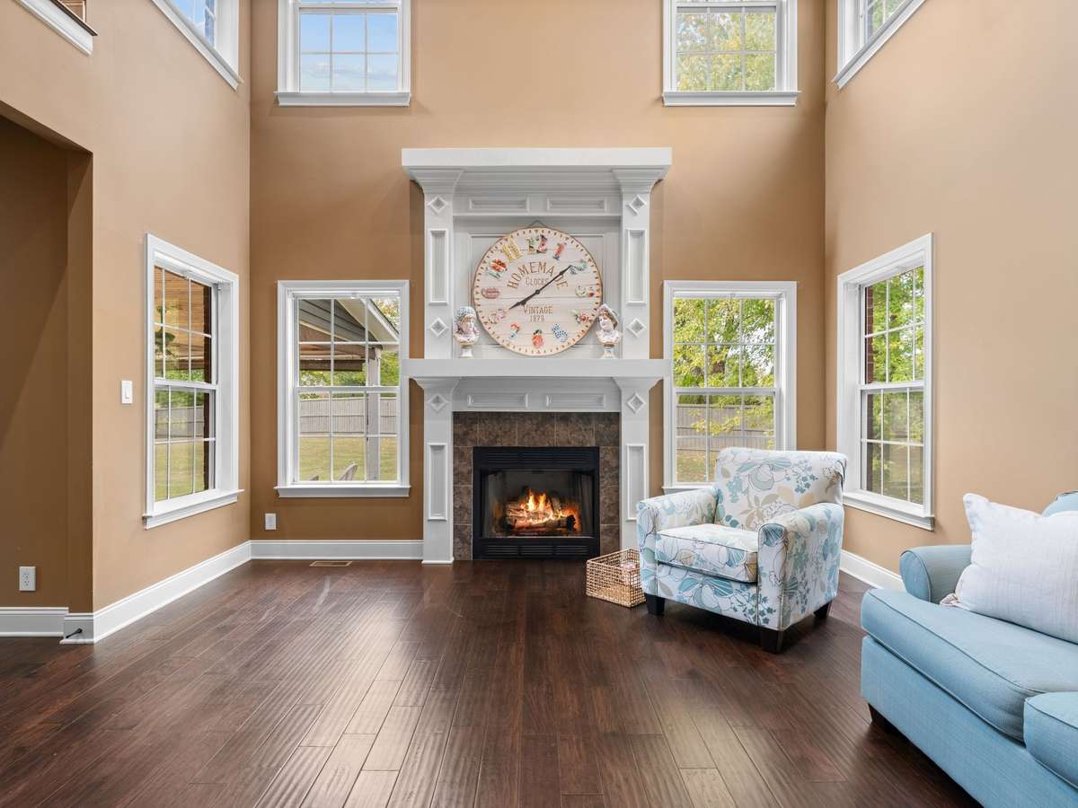 Inviting living room with stone fireplace, custom built-ins, and abundant natural light.