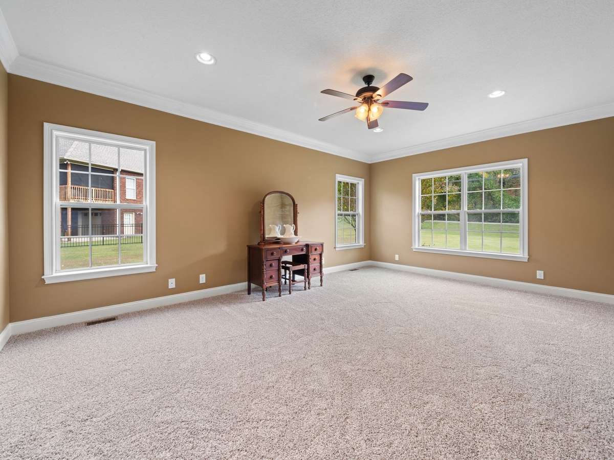 Spacious primary suite with ceiling fan, and plenty of natural light.