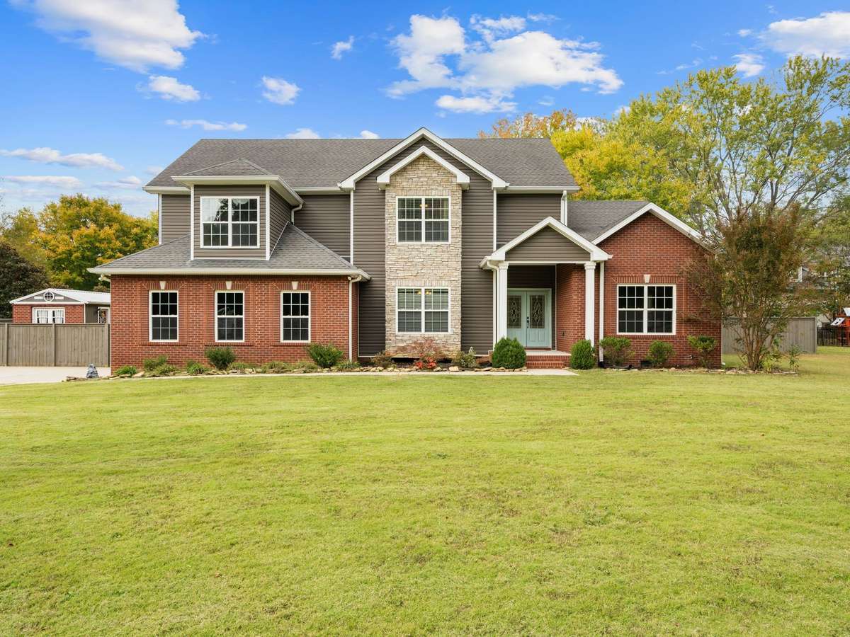 Beautiful brick and stone exterior with covered front porch and 2-car garage in the desirable Sango community