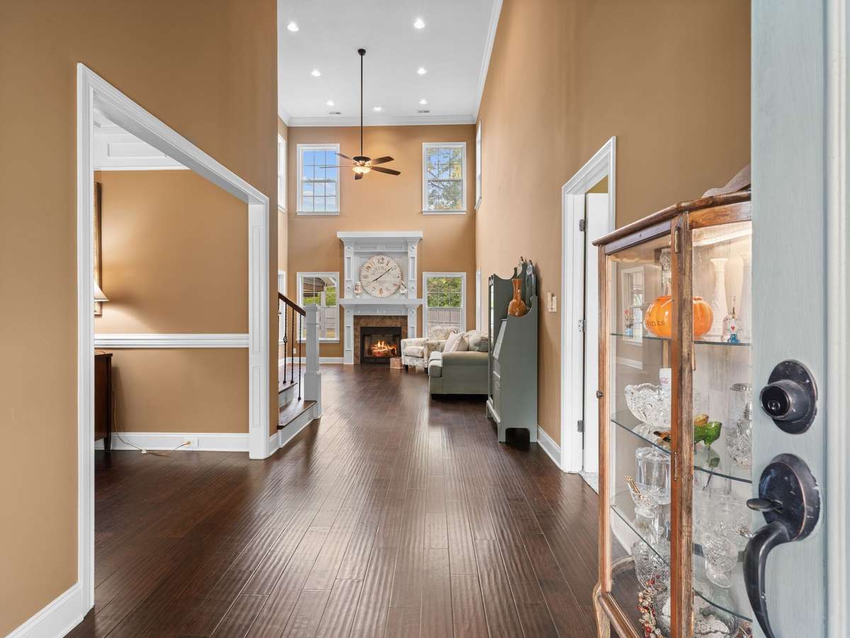Welcoming foyer with hardwood floors, staircase entry, and open flow to main living areas.