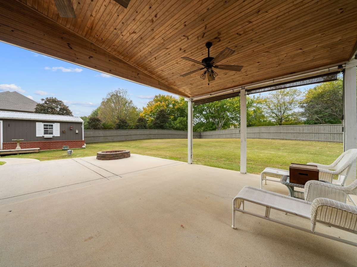 Private backyard—perfect for relaxing, pets, or entertaining. Fence has gate on the left for entry to golf course.