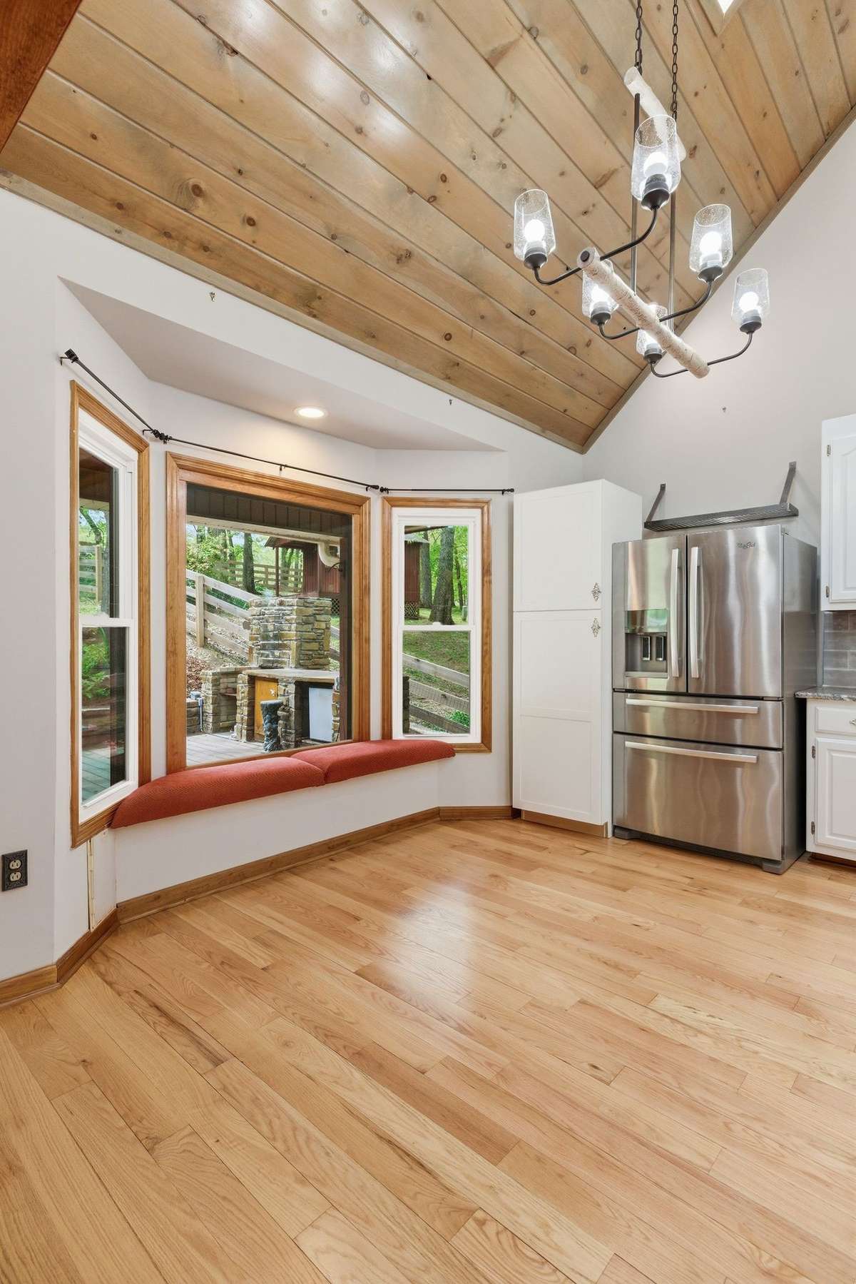 breakfast area with bay window and blue pine ceiling. Two refrigerator location options in the kitchen