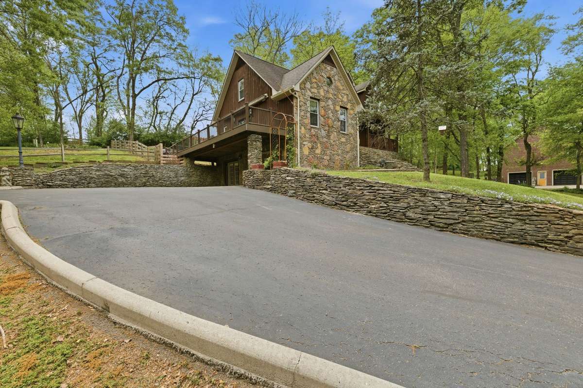 stacked stone, concrete curbing and asphalt driveways