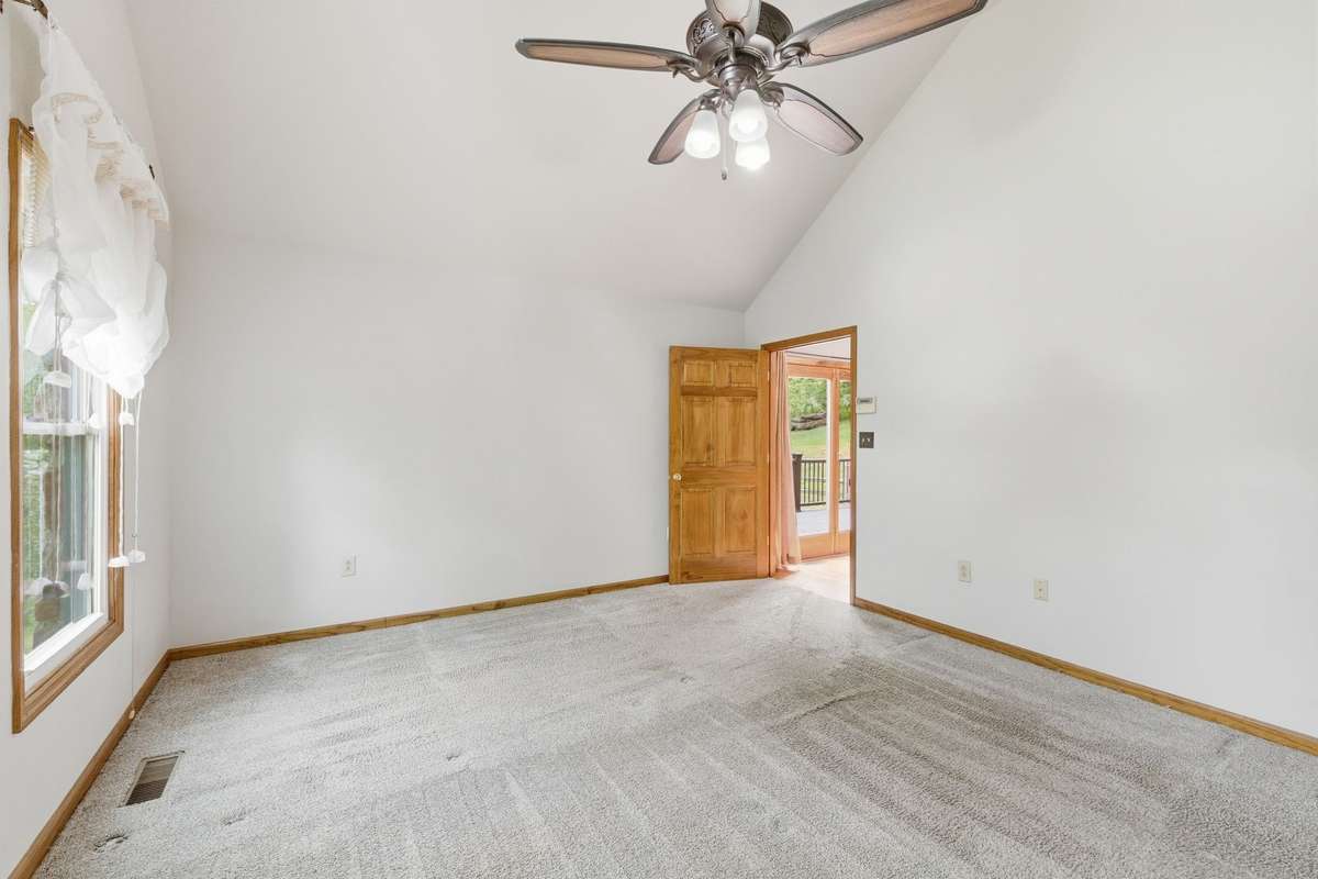 primary bedroom with doors to the deck