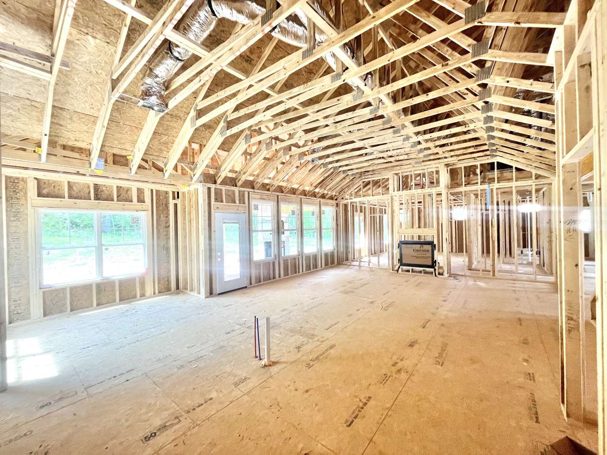 This is the view from the kitchen wall, looking across the great room. Can you imagine all of the decorating possibilities and all of the gatherings that could happen in this fantastic space. This great room is giving off some barndominium vibes, yes