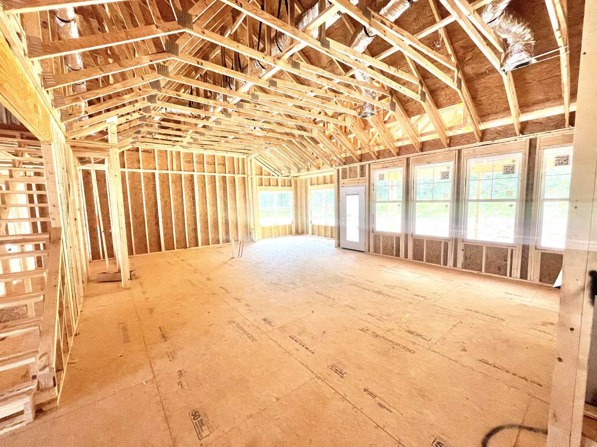 Looking across the great room into the future kitchen, you cannot help but notice wall of windows and the 11 1/2 foot tall ceiling