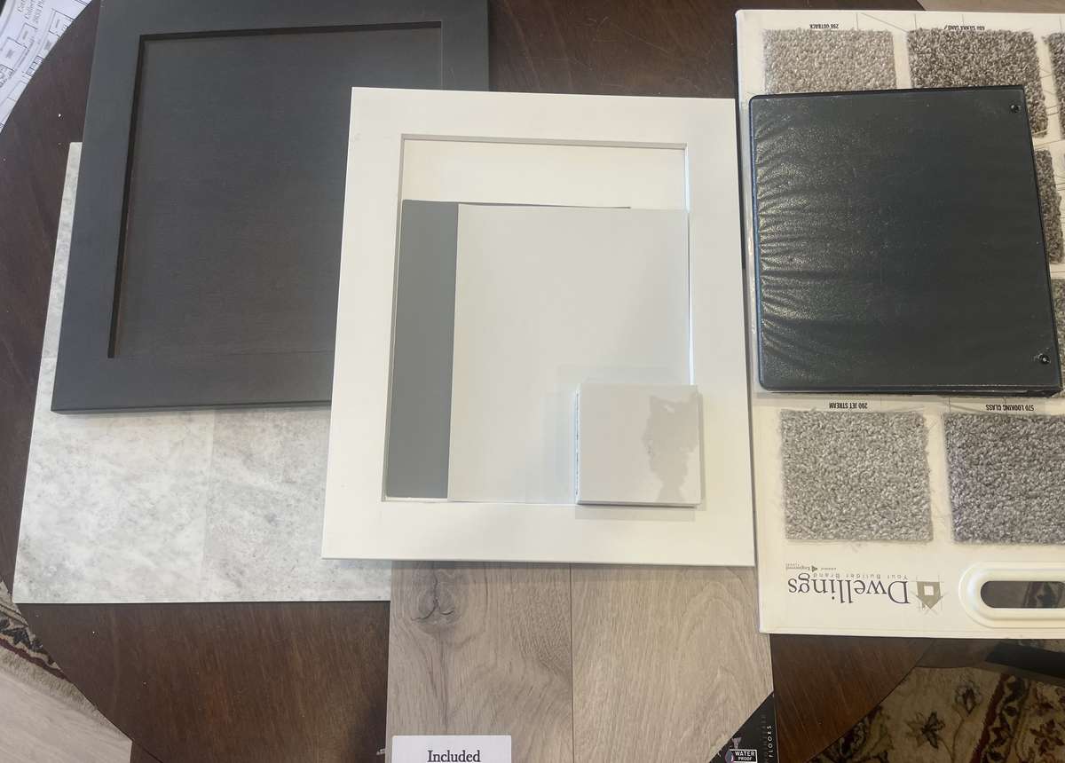 Beautiful laminate (Borneo by Dwellings) Jet Stream silver carpet, Kitchen cabinets Shaker White and large island and bathroom cabinets are Shaker Graphite. Blended color LVT in bathrooms and laundry. Walls are pale grey/white and a drk gry in GR,D,K