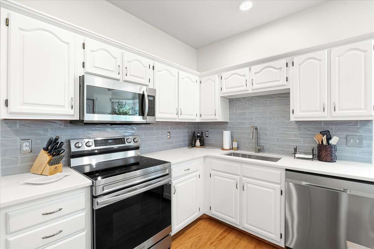 Beautifully updated with a stylish backsplash, quartz countertops, and newer appliances—light, bright, and ready to make you look like you have your life together.