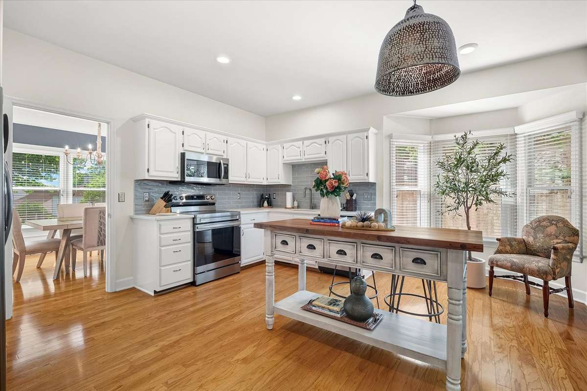 Open-concept living where it matters most. Yes, the laundry is in its original (and surprisingly convenient) location—but that just means you can tackle the “chore we adore” without missing a moment in the kitchen, where everyone naturally gather