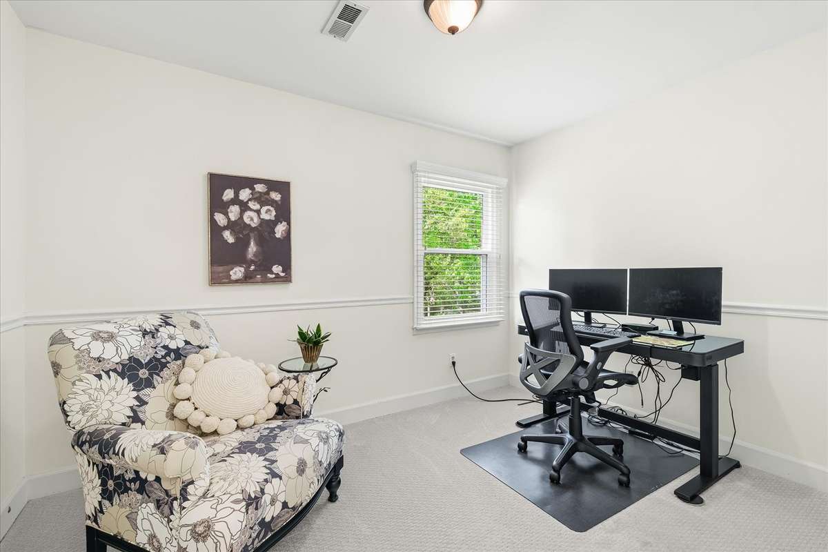 Two secondary bedrooms offer flexibility—one is currently styled as an office, proving it can work just as hard as you do.