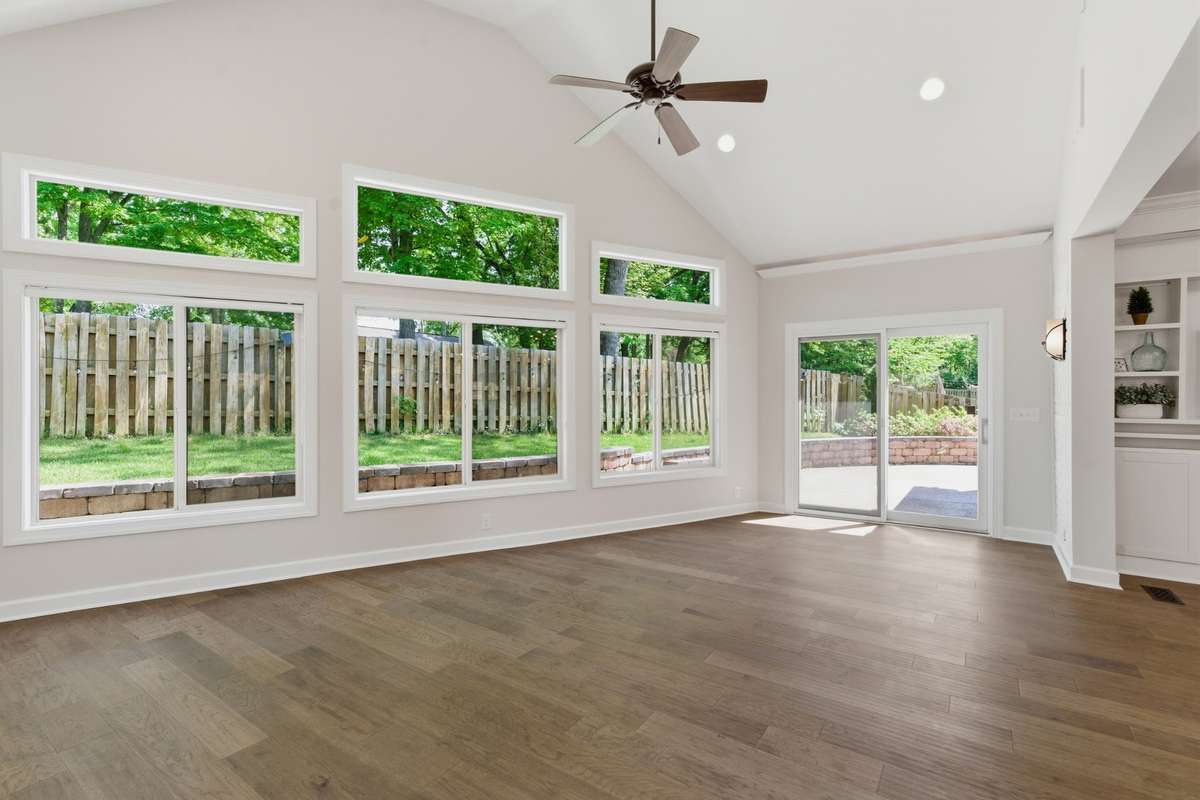 Stunning vaulted flex space is framed by a wall of windows, offering abundant natural light.