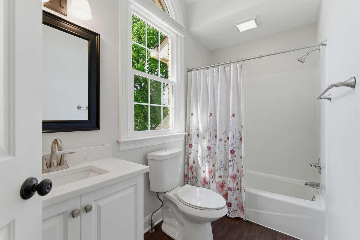 Upstairs hall bath featuring new counter tops, faucet and toilet.