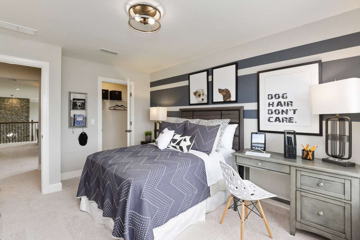 Spacious secondary bedrooms upstairs with walk-in closets. Photos are of model home.