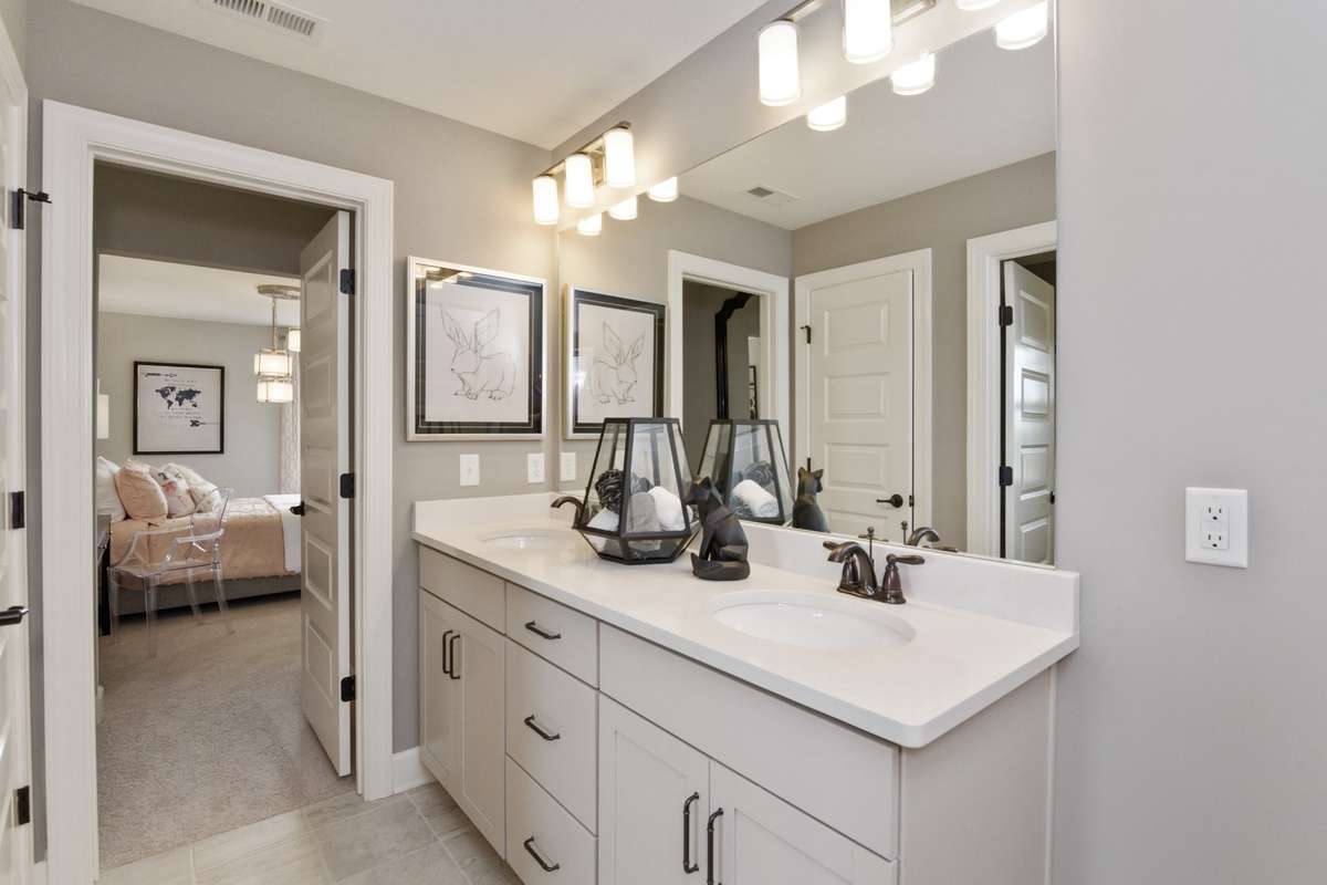 Jack and Jill bathroom upstairs for seamless floorplan flow. Photos are of model home.