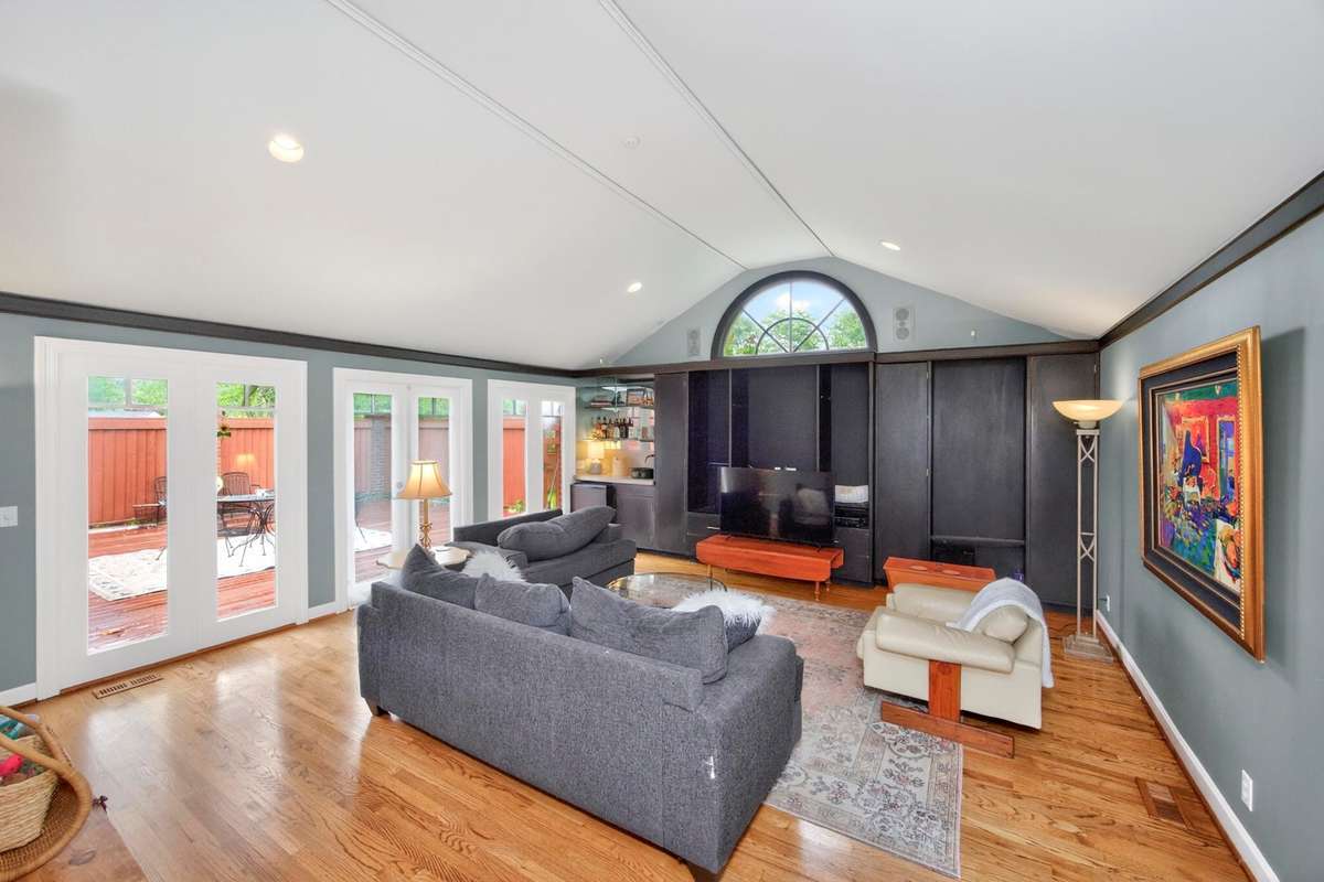 Huge den with built in bookcase. Look at those vaulted ceilings. All doors lead to the rear patio. :)