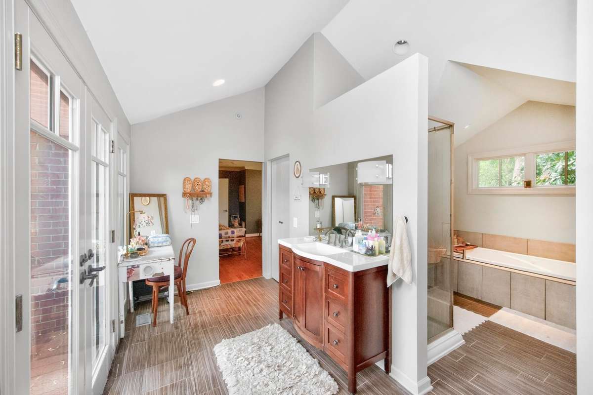 Primary bathroom with doors leading to the patio