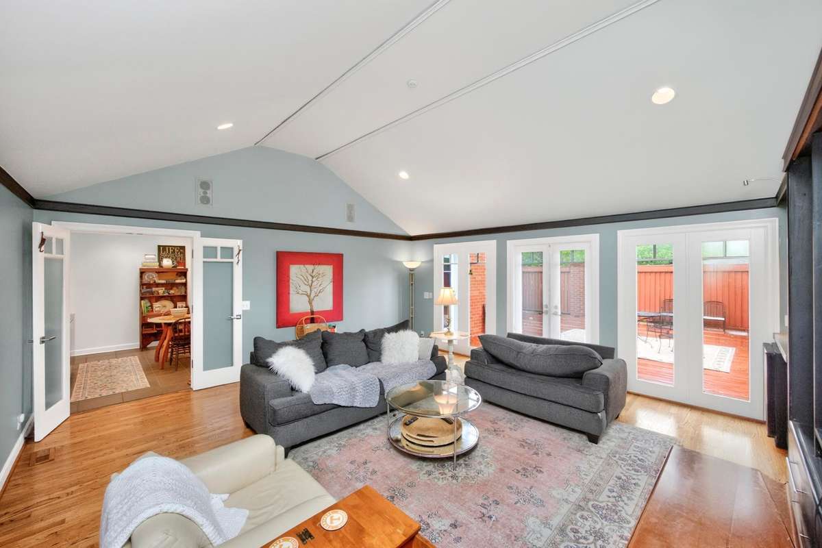 Huge den with built in bookcase. Look at those vaulted ceilings. All doors lead to the rear patio. :)