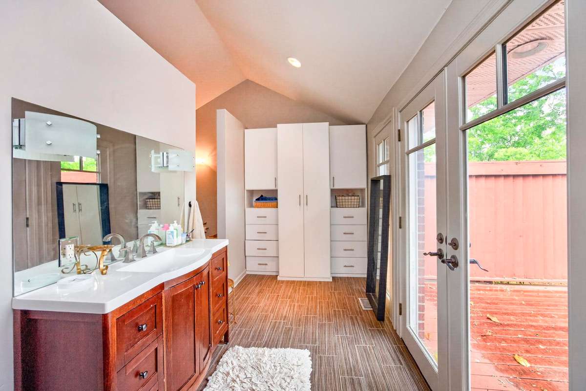 Primary bathroom with doors leading to the patio