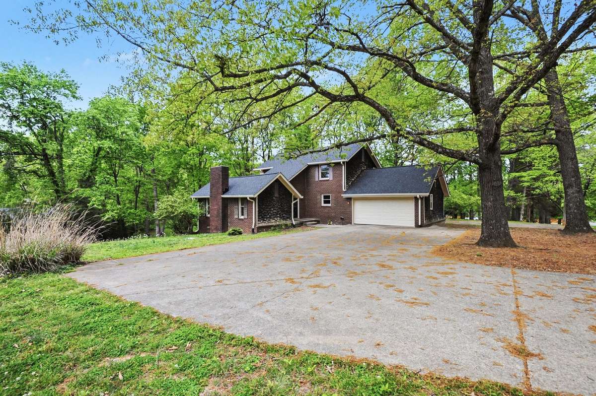 This home features a contemporary design situated on a large, corner lot with mature trees that feels like its in the woods!