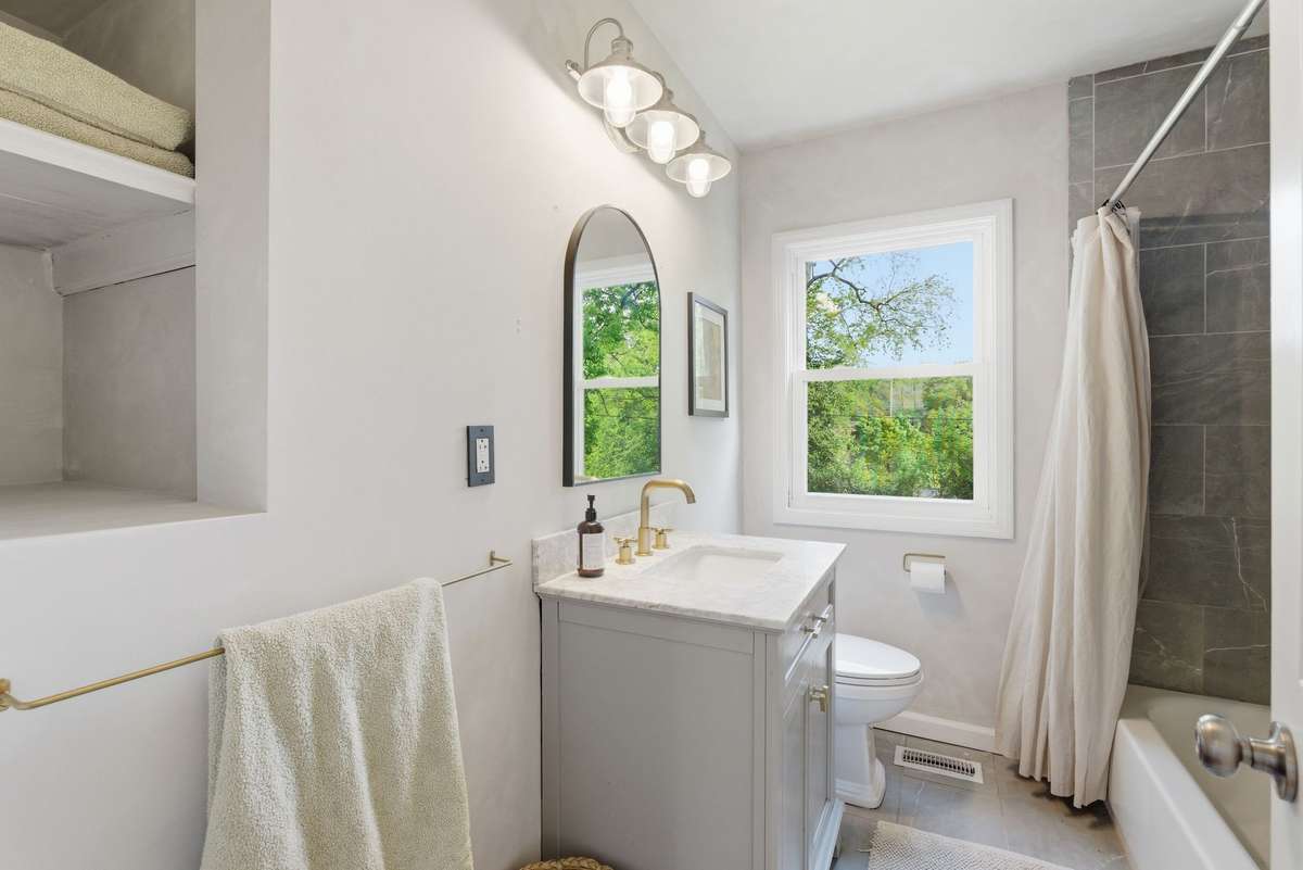 Cute bathroom in between with a tub and shower.