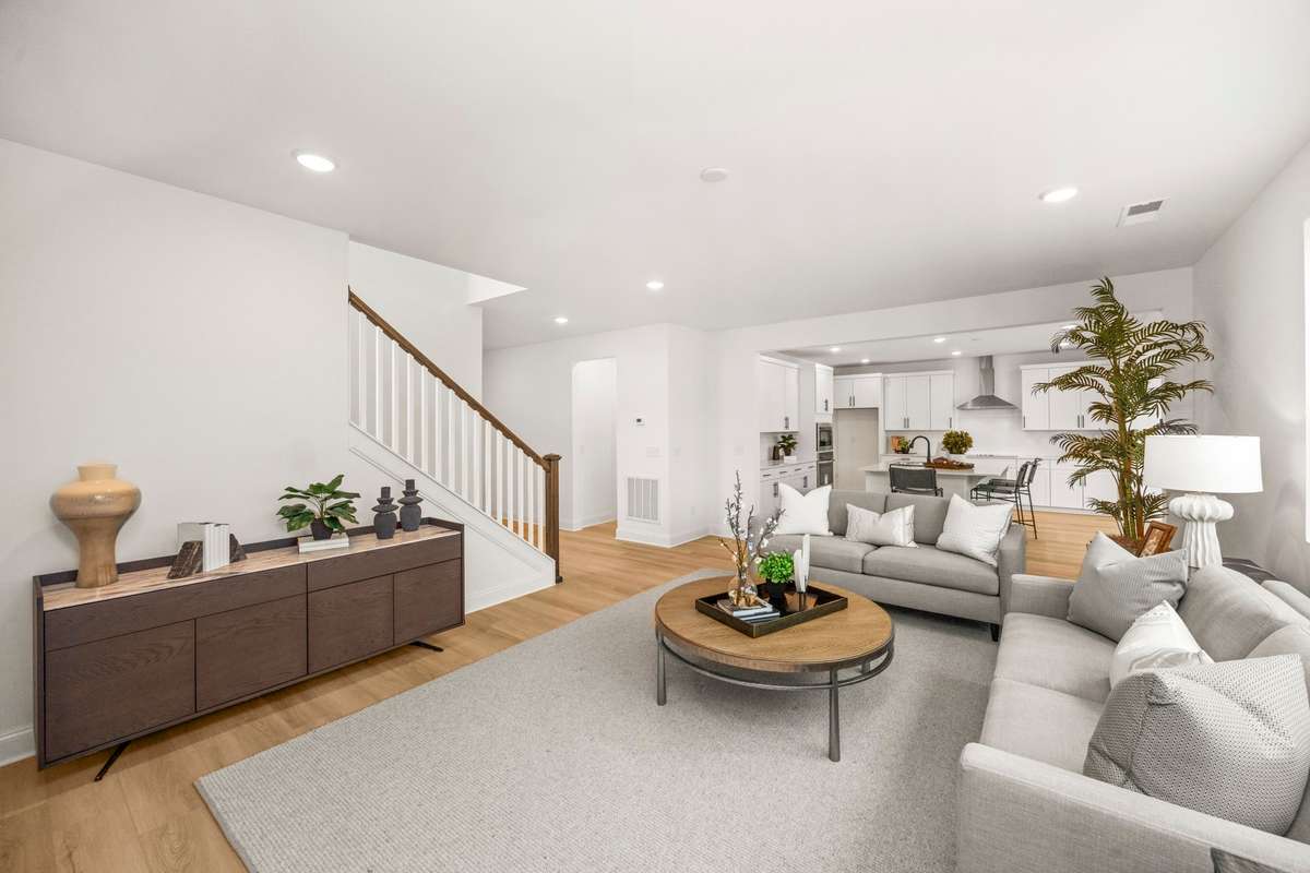Large living space with room for two full size couches.  Picture of decorated model home.