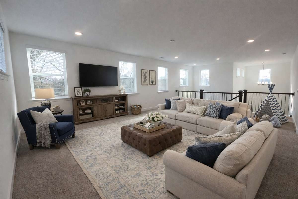 Plenty of space upstairs for family movie night.  Picture of decorated model home.