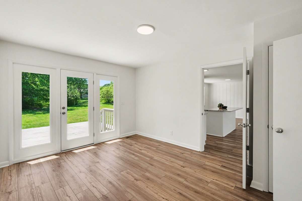 Family Room/Bonus Room with French Doors leading to the Fenced-in Back Yard