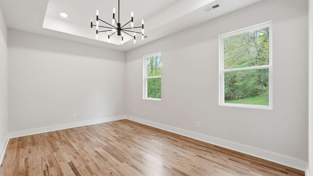 Large primary bedroom with tray ceilings