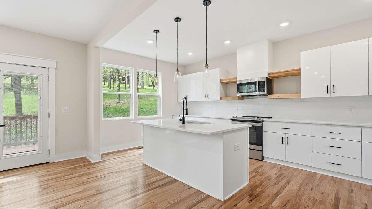 Open kitchen with large island and open shelving