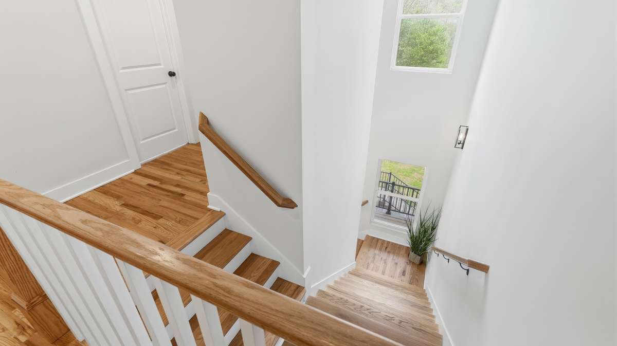 View of hardwood stairs to upstairs