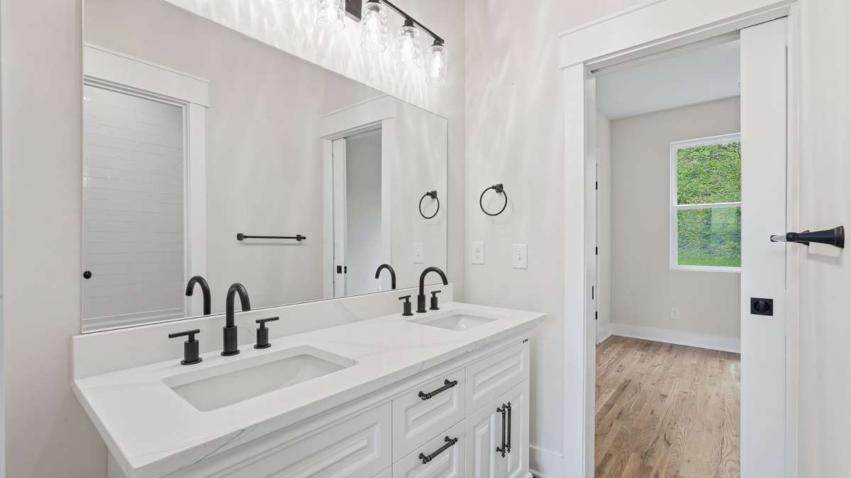Walk through bathroom between bedrooms 2 & 3 with double vanities