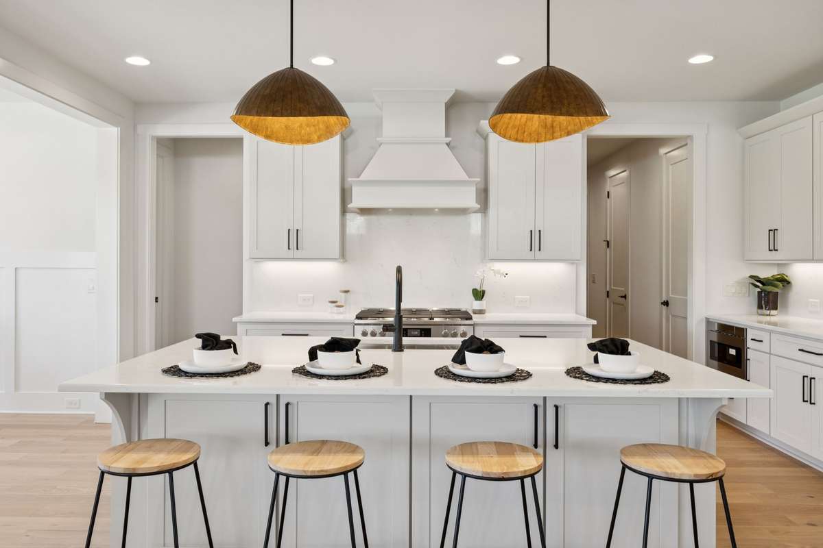 Hand Selected Modern Light Fixtures, Under Cabinet Lighting, Quartz Countertops, and a Generous Kitchen Island.
