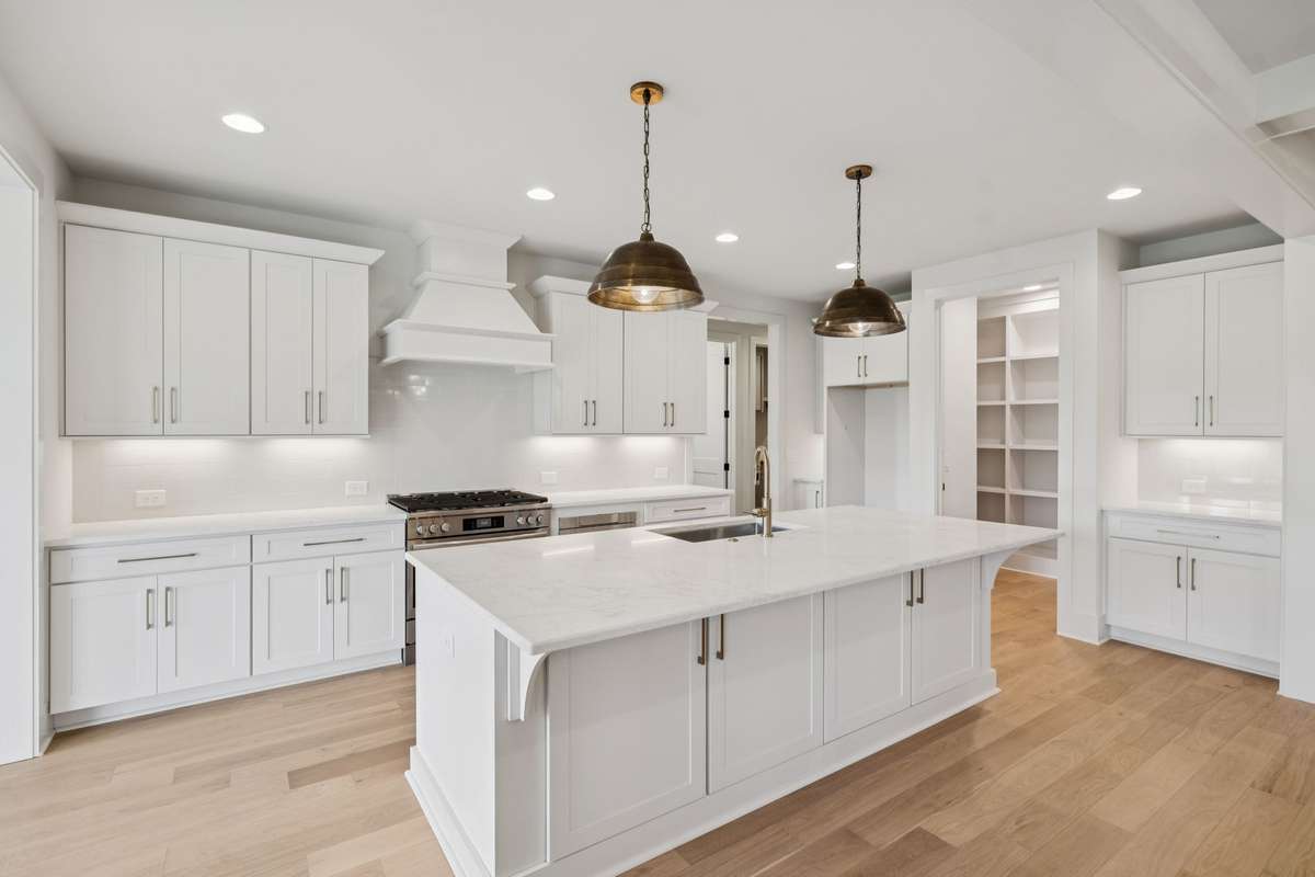 Gourmet Kitchen - Custom Cabinetry, Under Cabinet Lighting, a Generous Sized Island, Stylish, Quartz Countertops, Plus a Large Walk-in Pantry