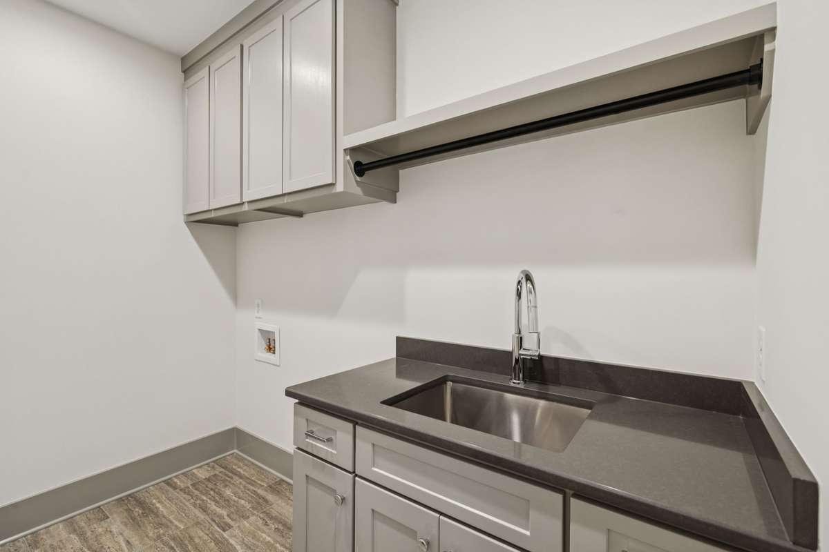 Laundry Room with Custom Cabinets and Quartz counter Sink. So Convenient!
