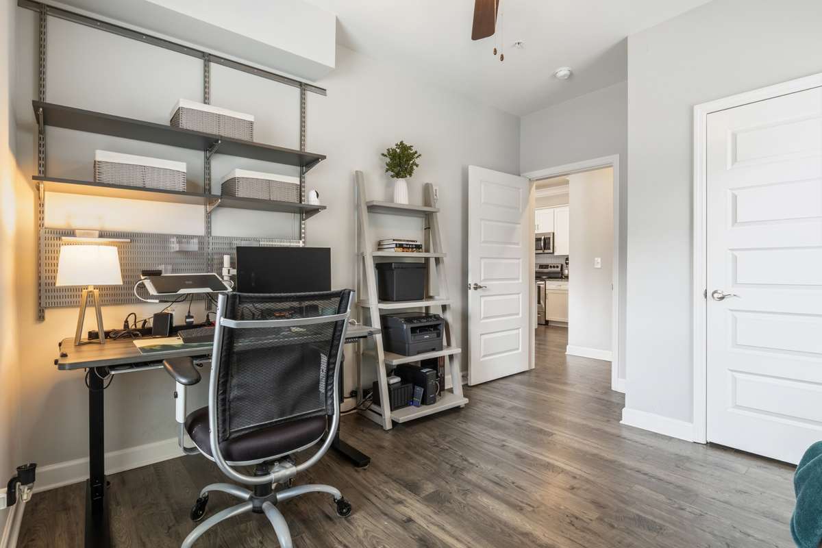 The secondary bedroom also has Mohawk sustainable hardwood floors and a ceiling fan and is located just off of the oversized guest bathroom.