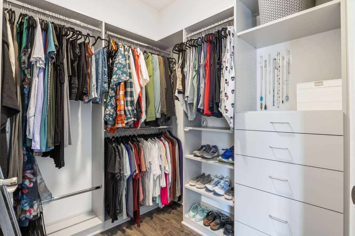 A custom closet system makes great use of the walk-in closet space of the owner's suite.