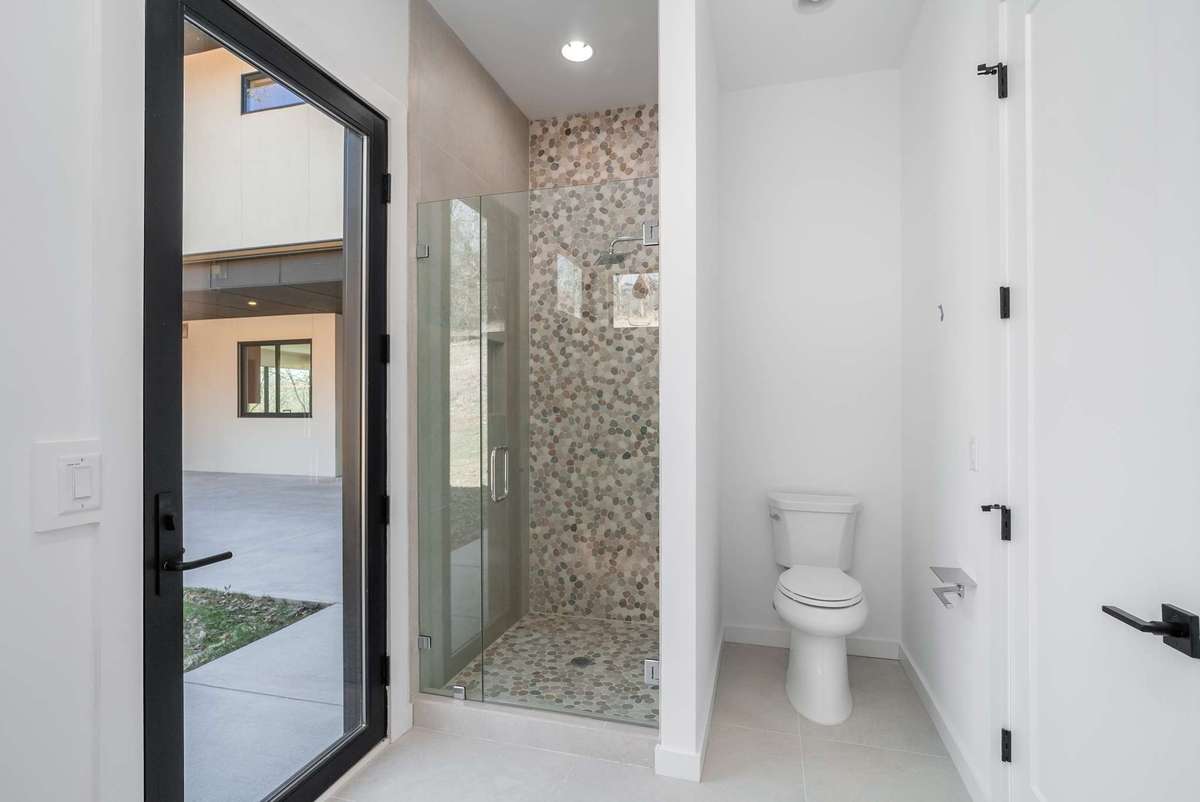 Family room wing shower with direct access to the patio deck.