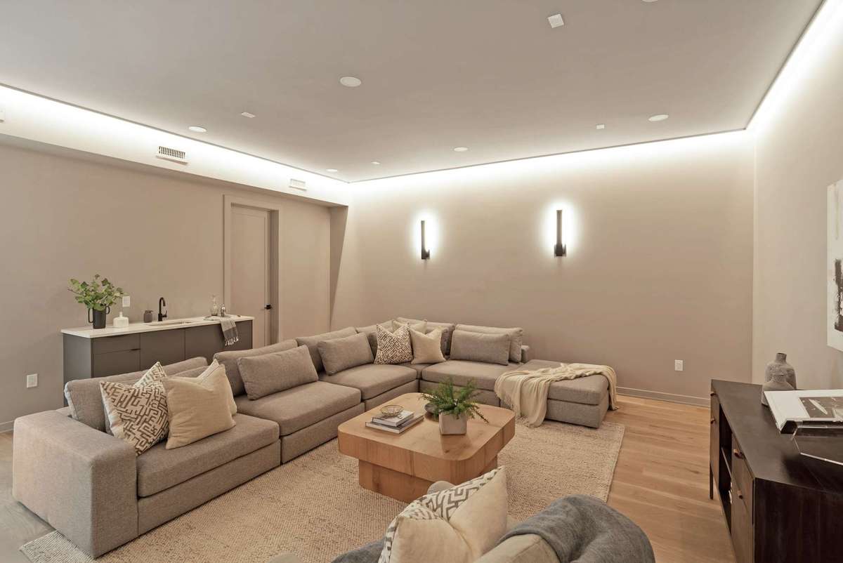 The theater room includes a wet bar and two accessible storage closets as well as a full size refrigerator hookup.