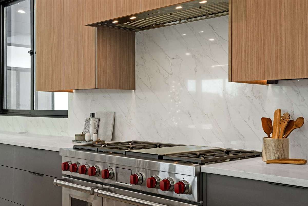 Wolf range with double oven plus the entire backsplash wall wrapped in quartz.