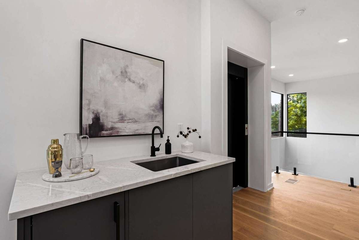 Wet bar with ice maker conveniently placed between the living room and the conversation area.
