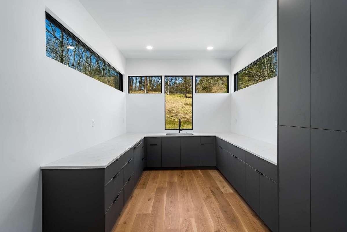 The pantry also features a prep sink and additional cabinet front dishwasher along with ample cabinets and storage