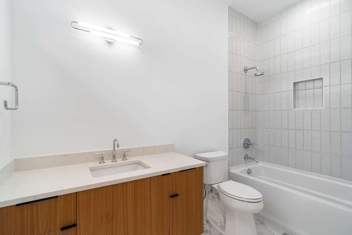 Bedroom 3 bath with tub (the photo is not true to color on the countertop)