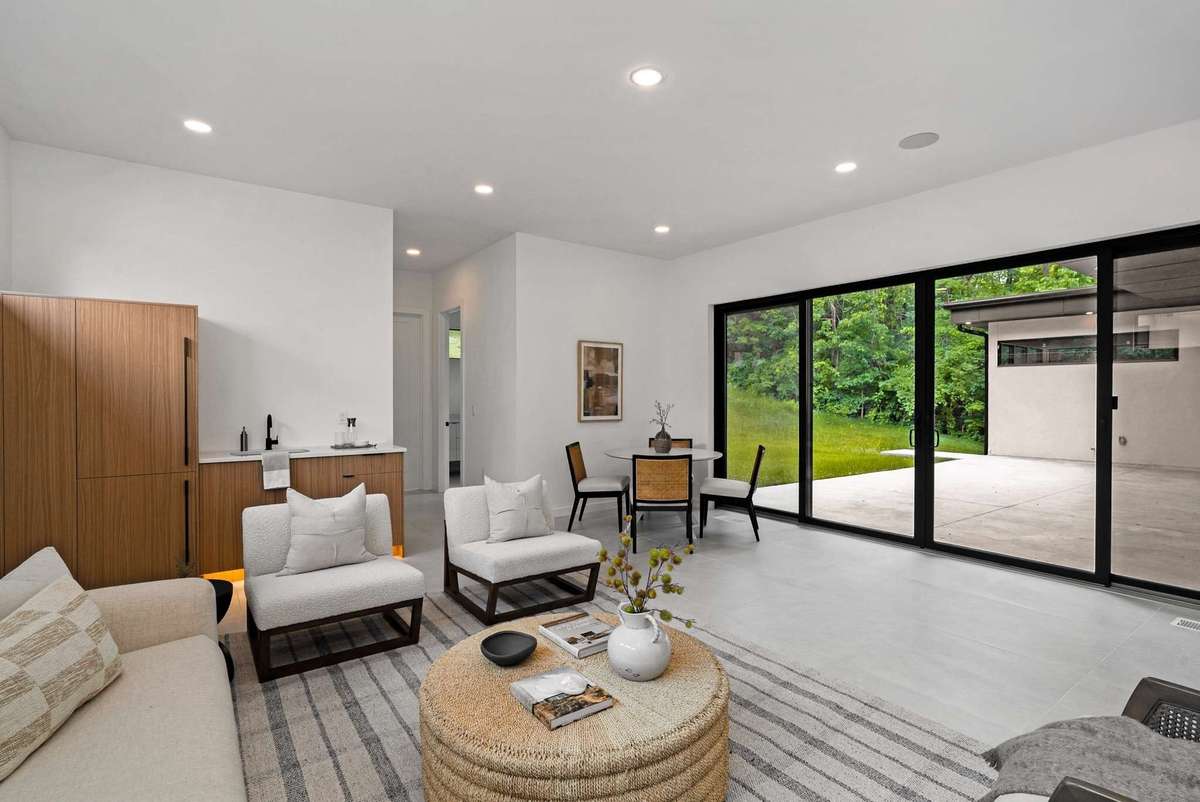The hallway leads to the family room full bath with shower, storage and additional laundry.