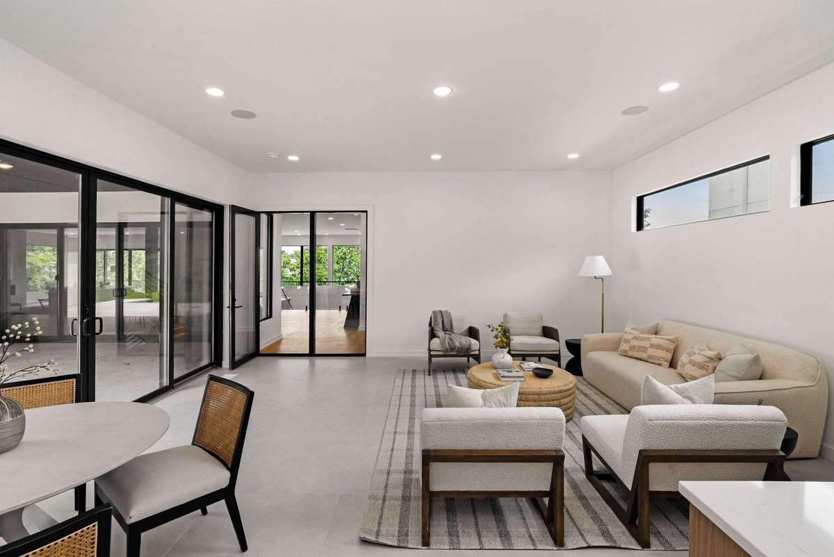 The door from the family room to the rest of the house has an exterior door with a side light. You can close off this room to the rest of the house and leave the sliders open.