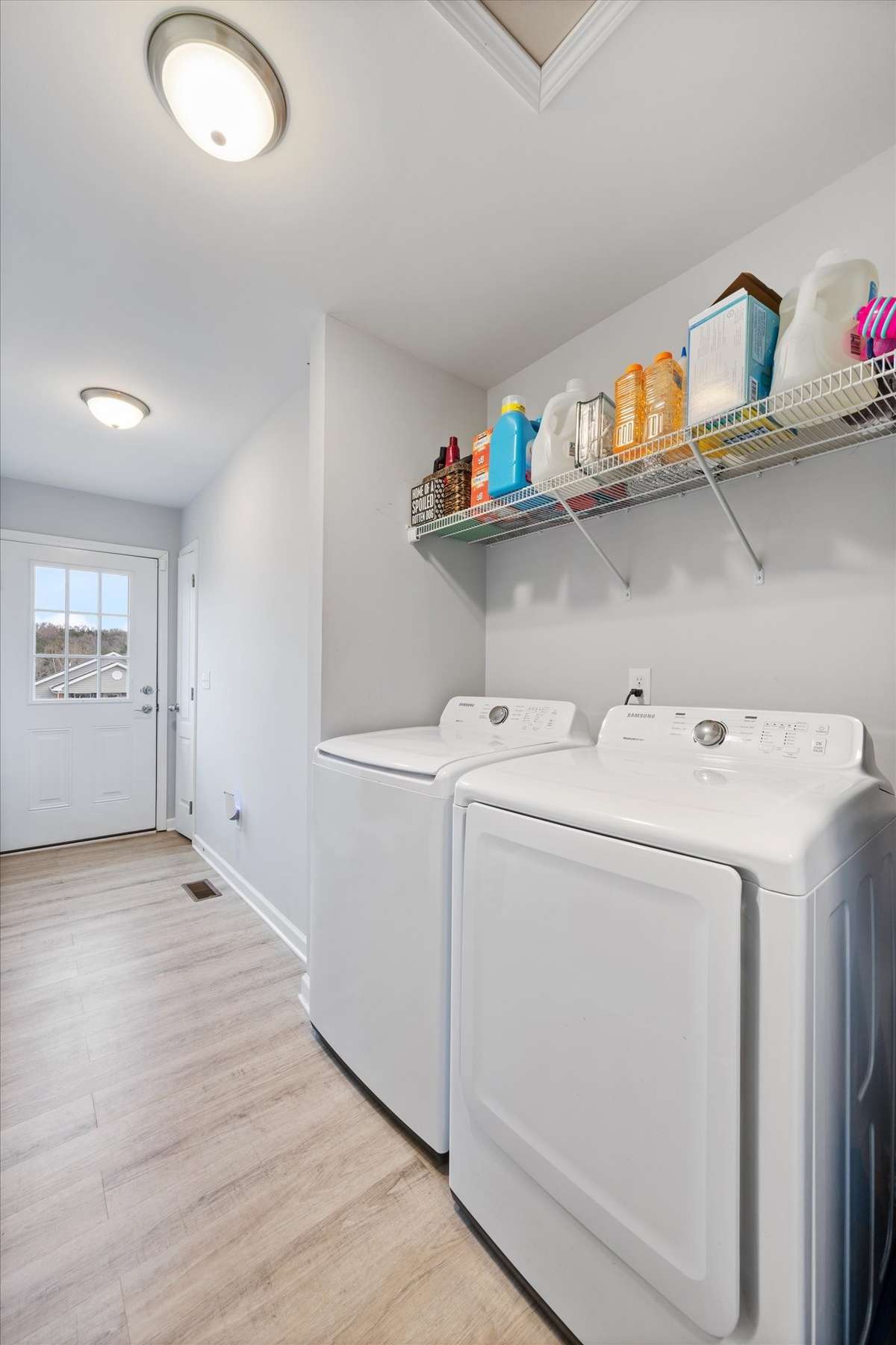 Large walk through laundry and storage room that leads to the back deck.